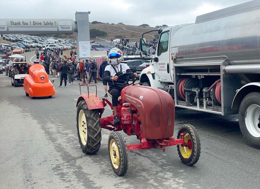 McElrea Racing driver Matt Campbell driving a Porsche tractor at Laguna Seca, California 2023